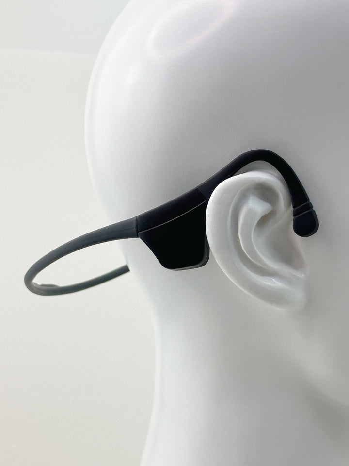 Black LyteFlyte on a mannequin ear with a plain background